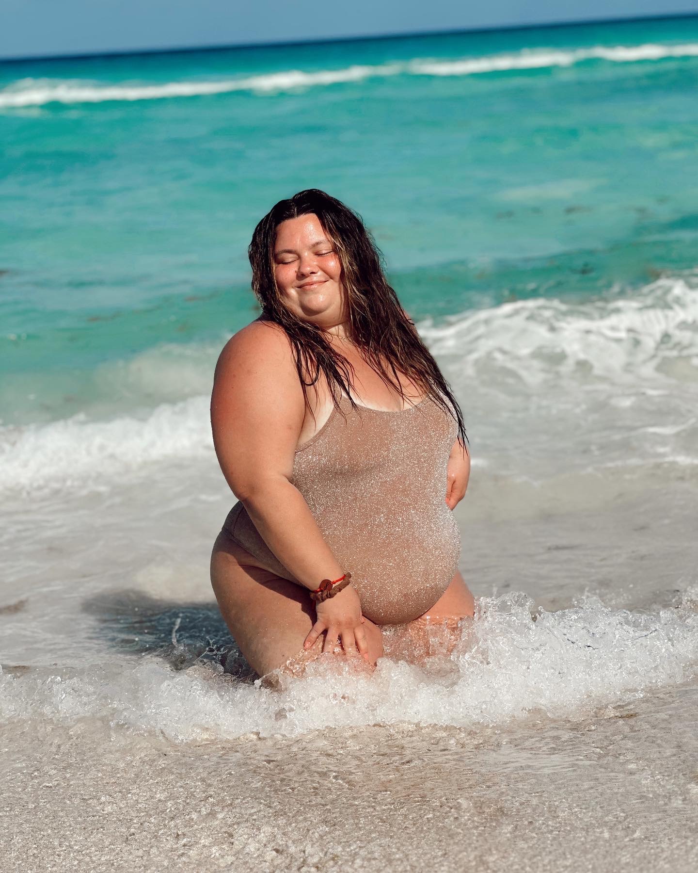 Where to buy plus size swimwear from Natalie in the City who is wearing SKIMS one piece in Cancun