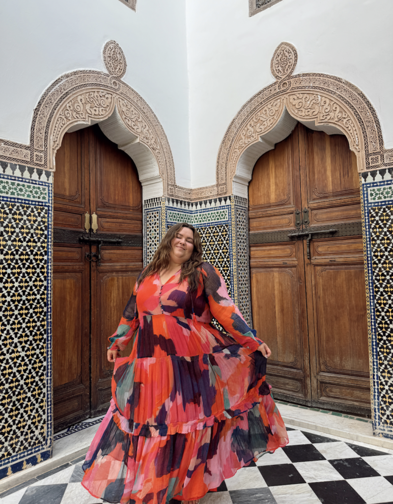 plus size woman at Dar Al Bashar in Marrakech, Morocco wearing a flowy dress