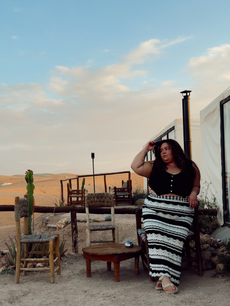 plus size woman in the Agafay Desert in Morocco wearing a knitted skirt and cropped vest
